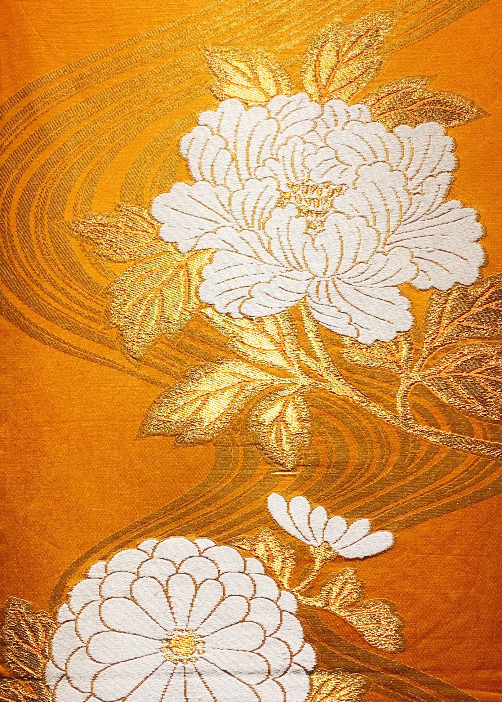 Gold silk woven with a white peony and chrysanthemums outlined in gold thread
