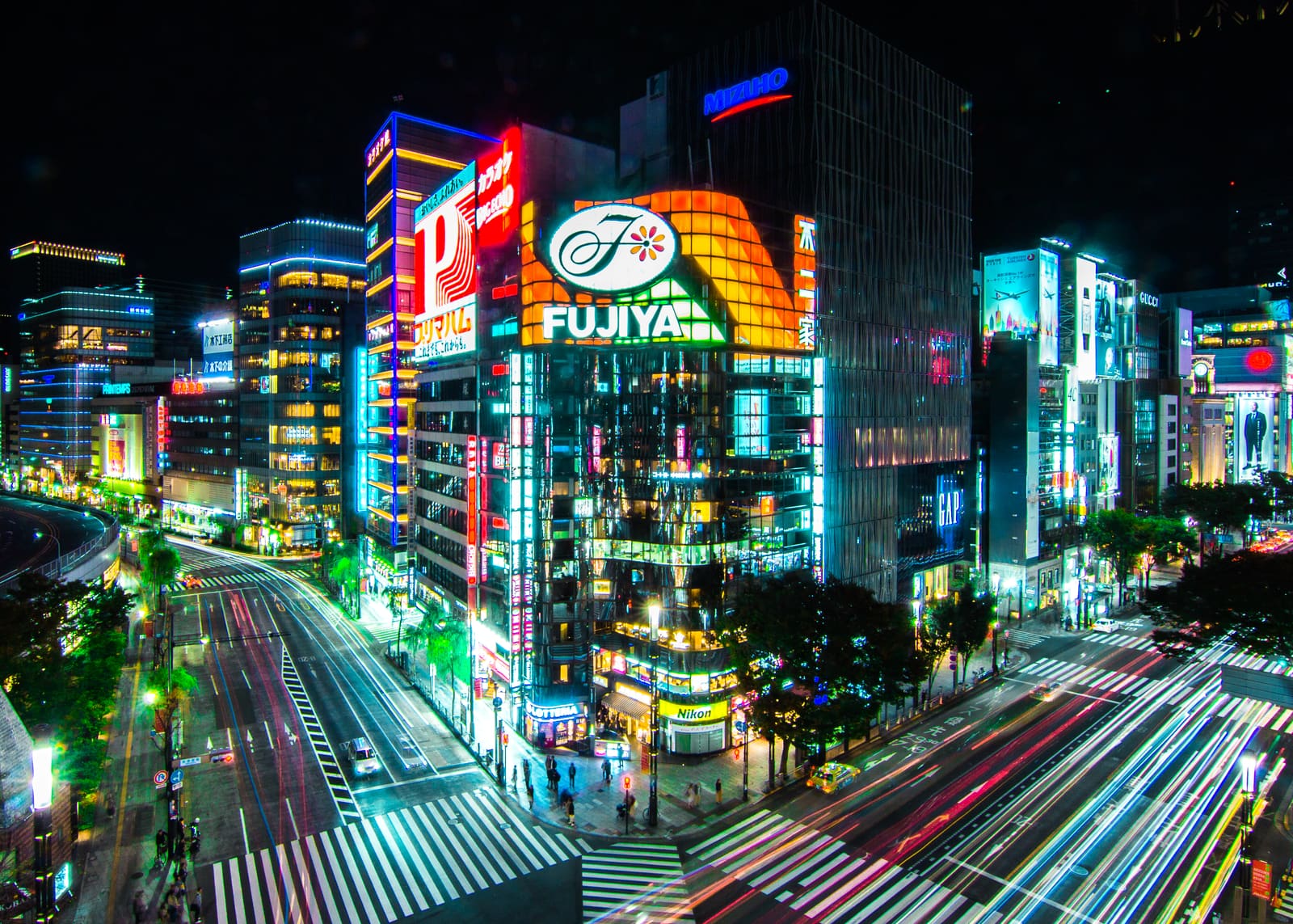 A Ginza crossing at night, the signs lit