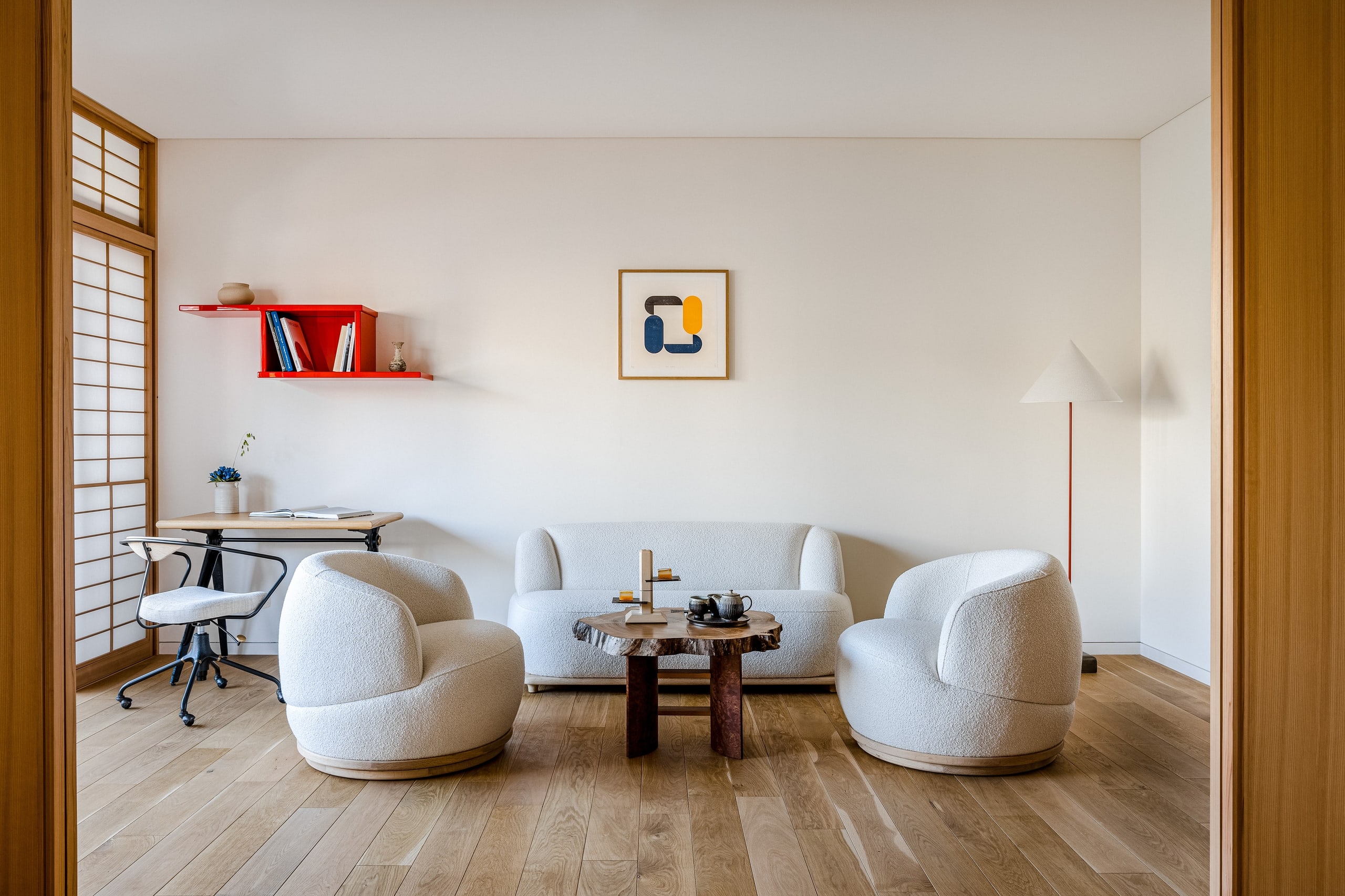 A suite living room in pale oak, a sofa and two round armchairs round a burr-wood table