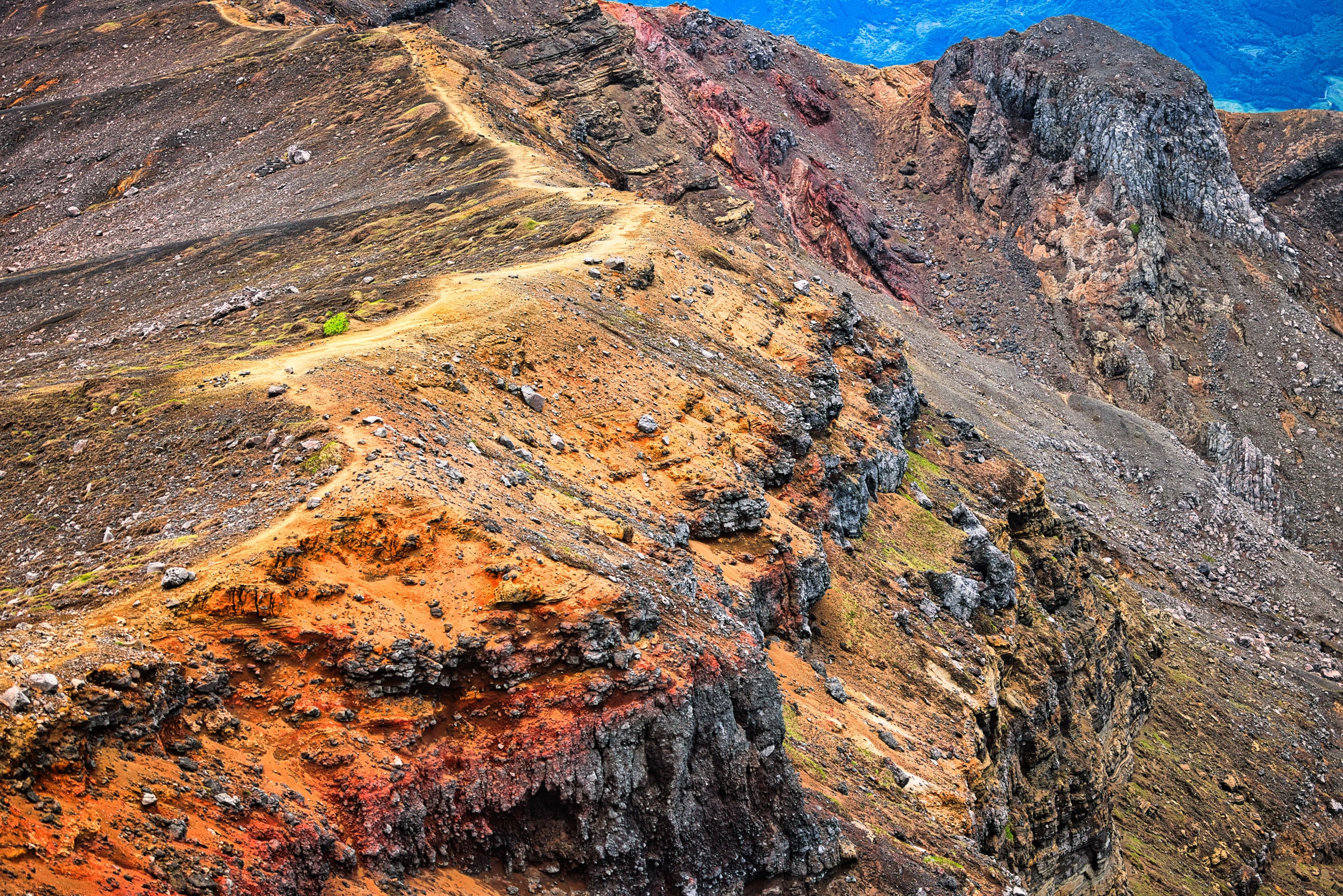 The red-streaked volcanic crater of Nakadake seen from the rim, Mount Aso