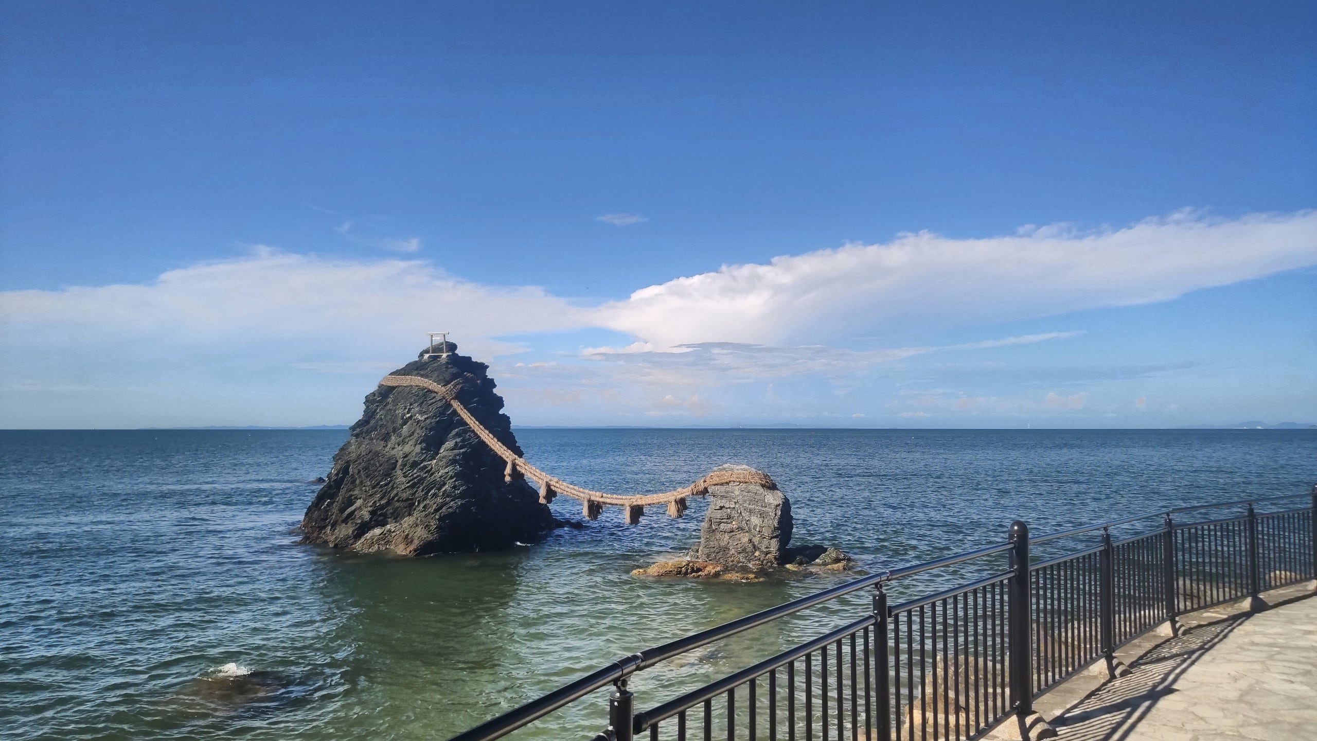 The two Meoto Iwa rocks standing in the sea at Futami, joined by a thick straw rope