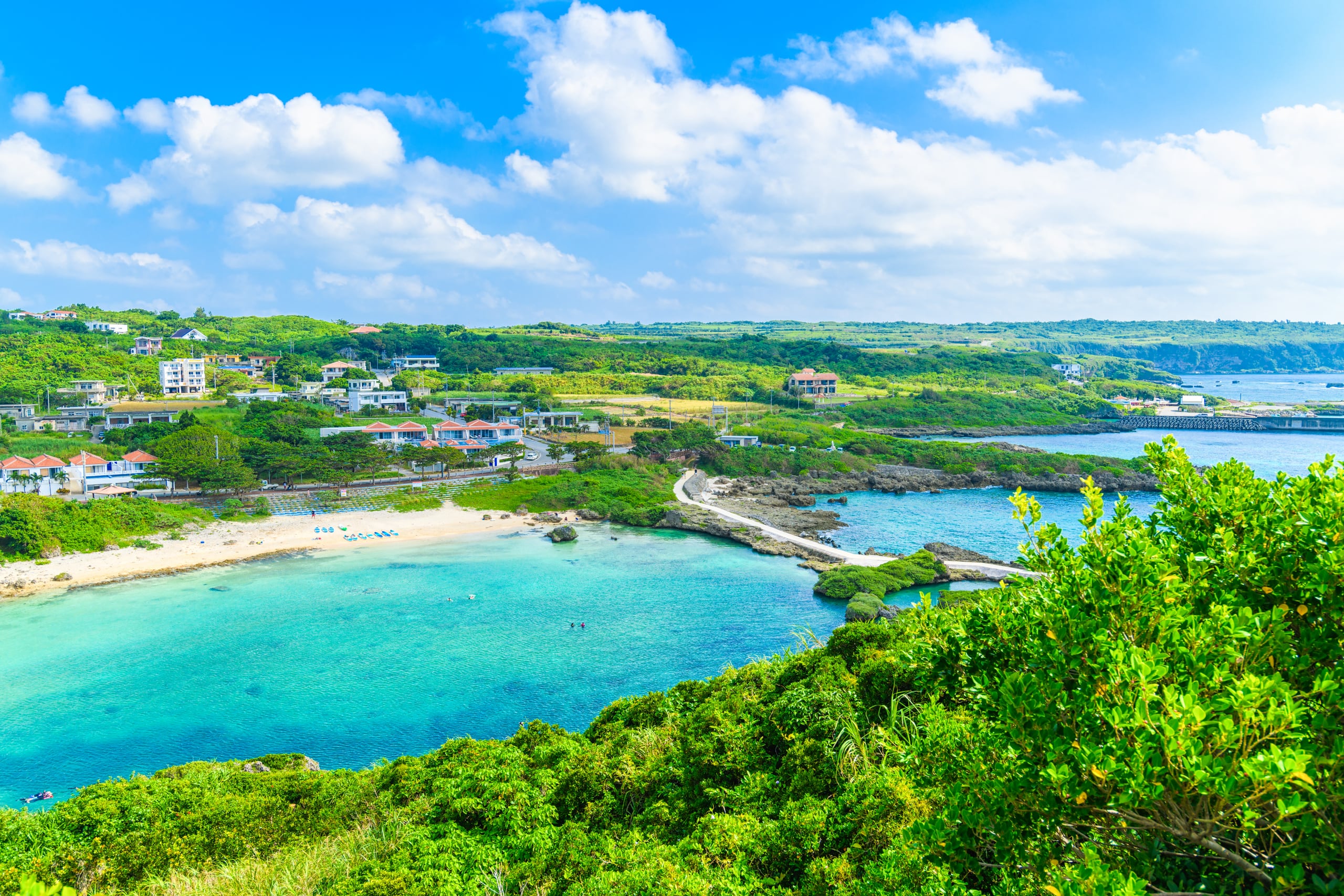 A turquoise cove and a curved beach of white sand opening to the sea, Miyakojima