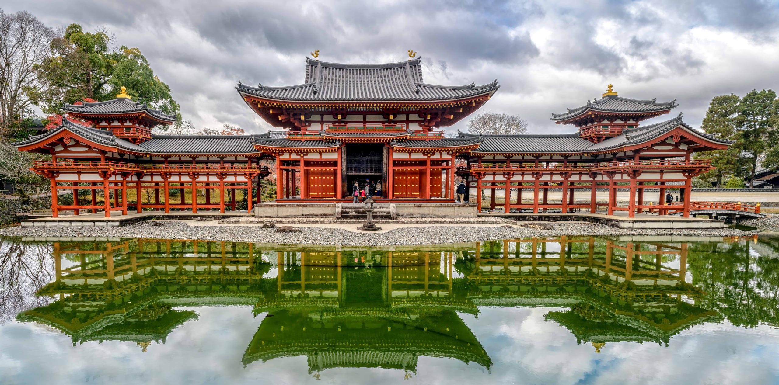 The vermilion and white Phoenix Hall of Byodo-in mirrored in its pond, Uji
