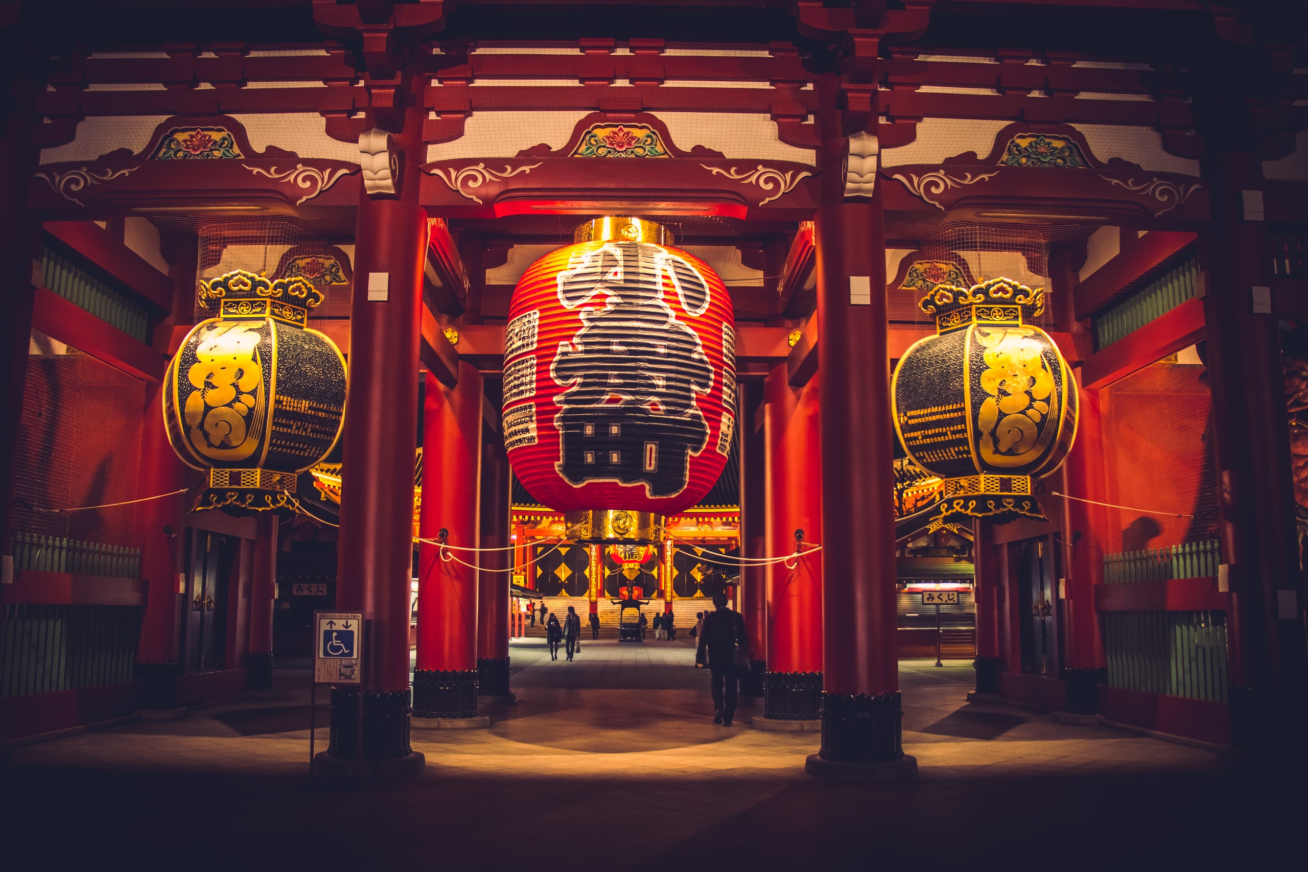 The great red lantern of the Hozomon gate at Senso-ji, Asakusa, lit at night between vermilion pillars