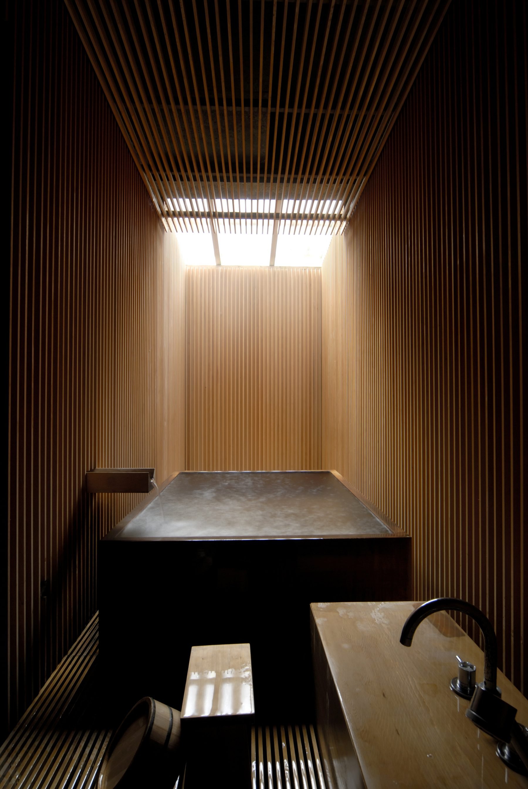 A private onsen at Fujiya, its cedar walls lit from a skylight above
