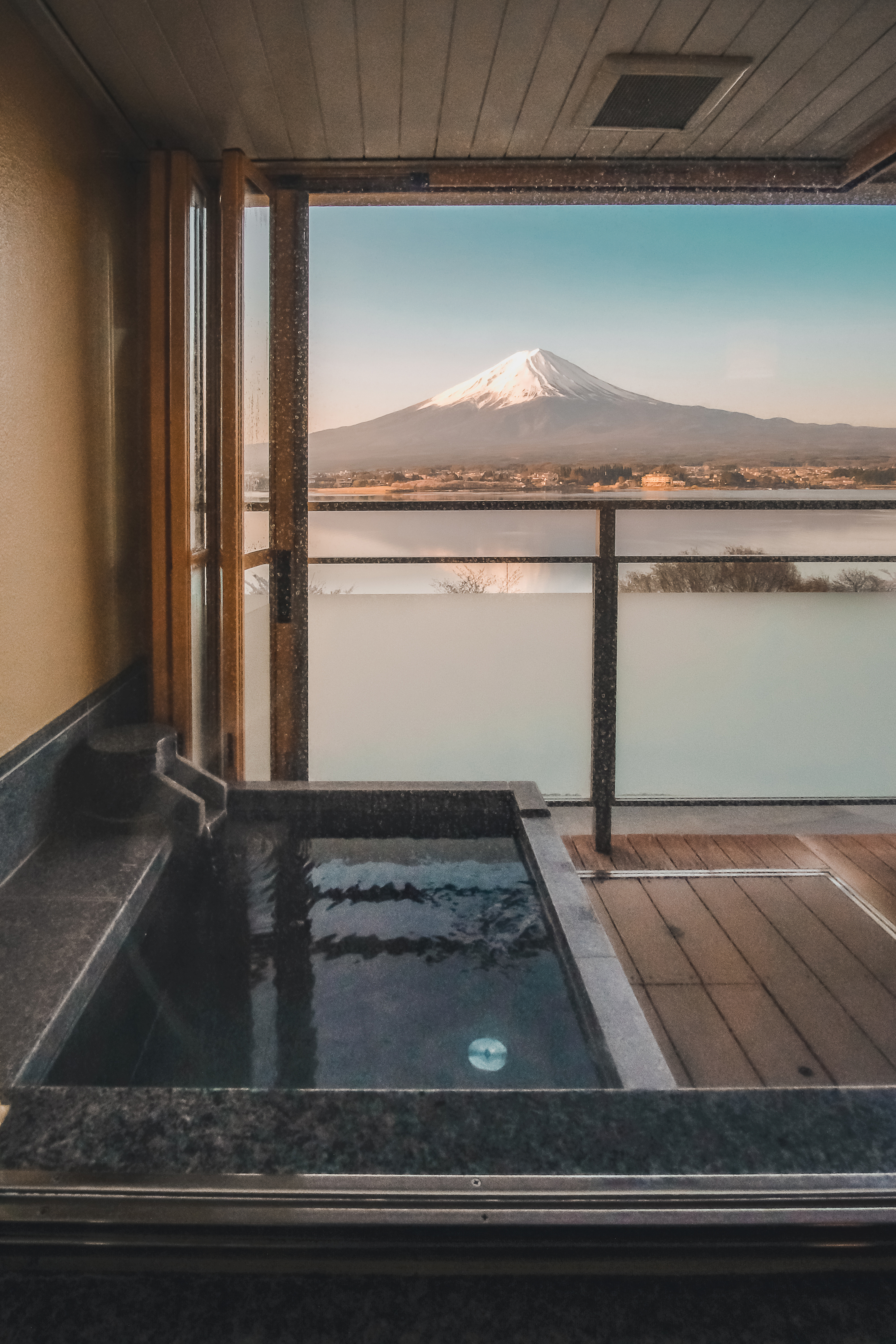 A private stone bath on an open-air balcony facing Mount Fuji