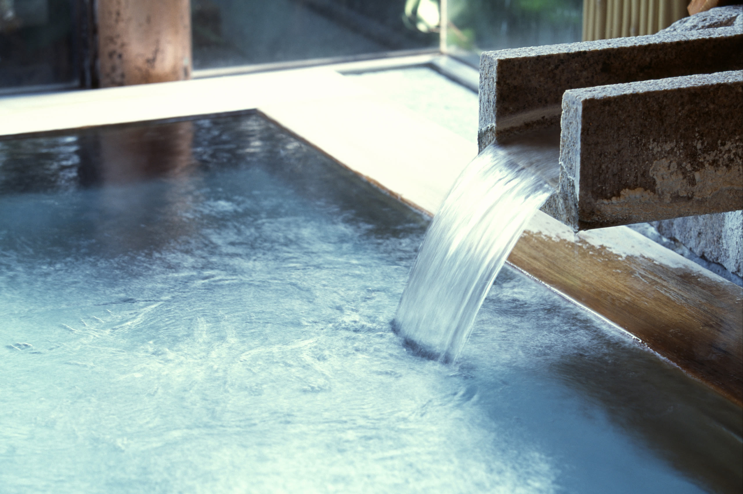 Hot spring water running into the bath
